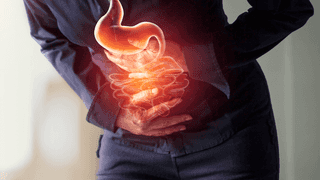 Person holding their stomach due to pain.