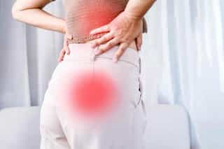 A person stretching to relieve sciatic nerve pain.
